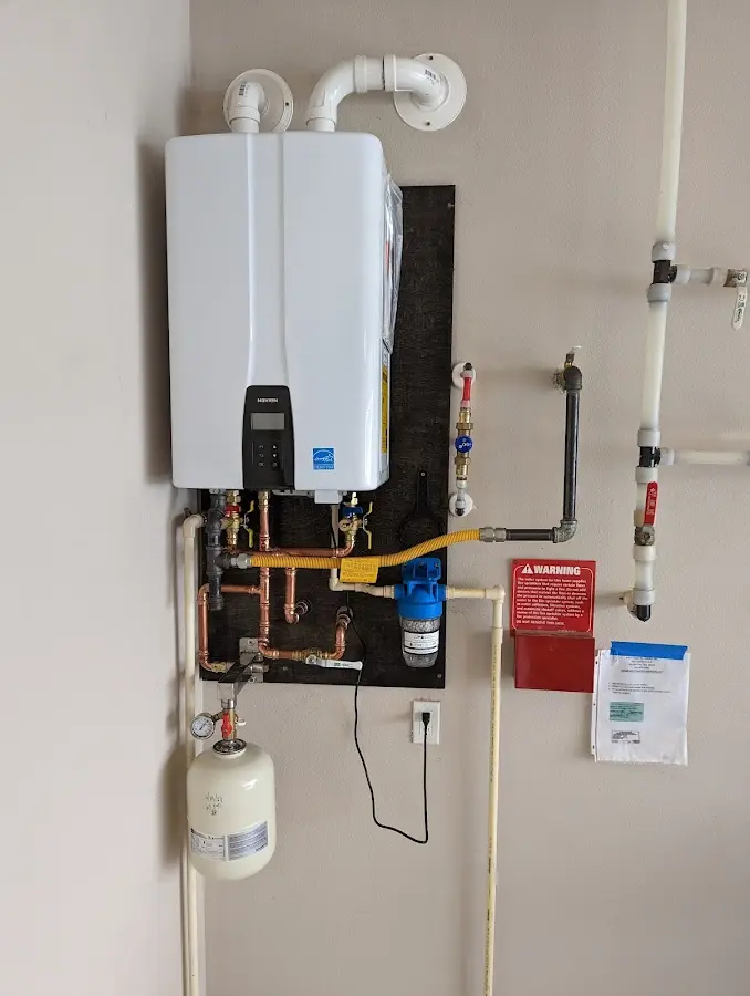 Professional plumber installing copper piping in a Northfield home